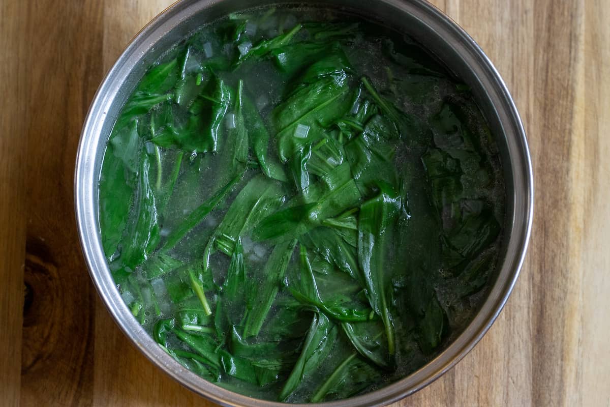 the wild garlic leaves are added to the pan