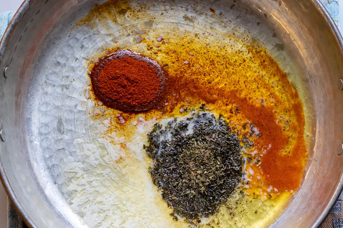 melted butter is infused with paprika and dried mint for drizzling on Mercimek Corbasi 