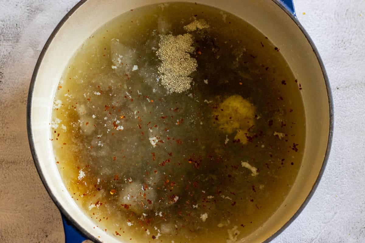 chicken stock, chili, ginger, mirin, salt, sugar and soy sauce are added in a dutch oven