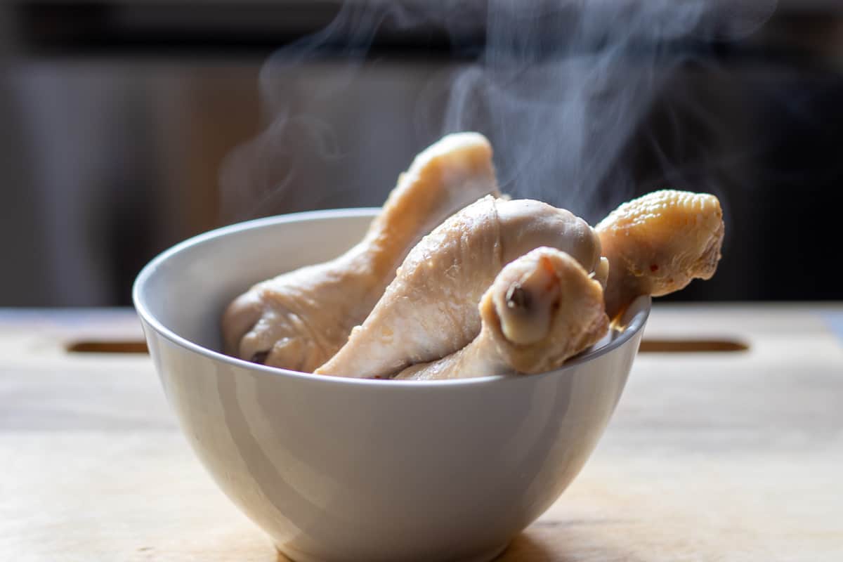 cooked chicken is remover to a plate for cooling down