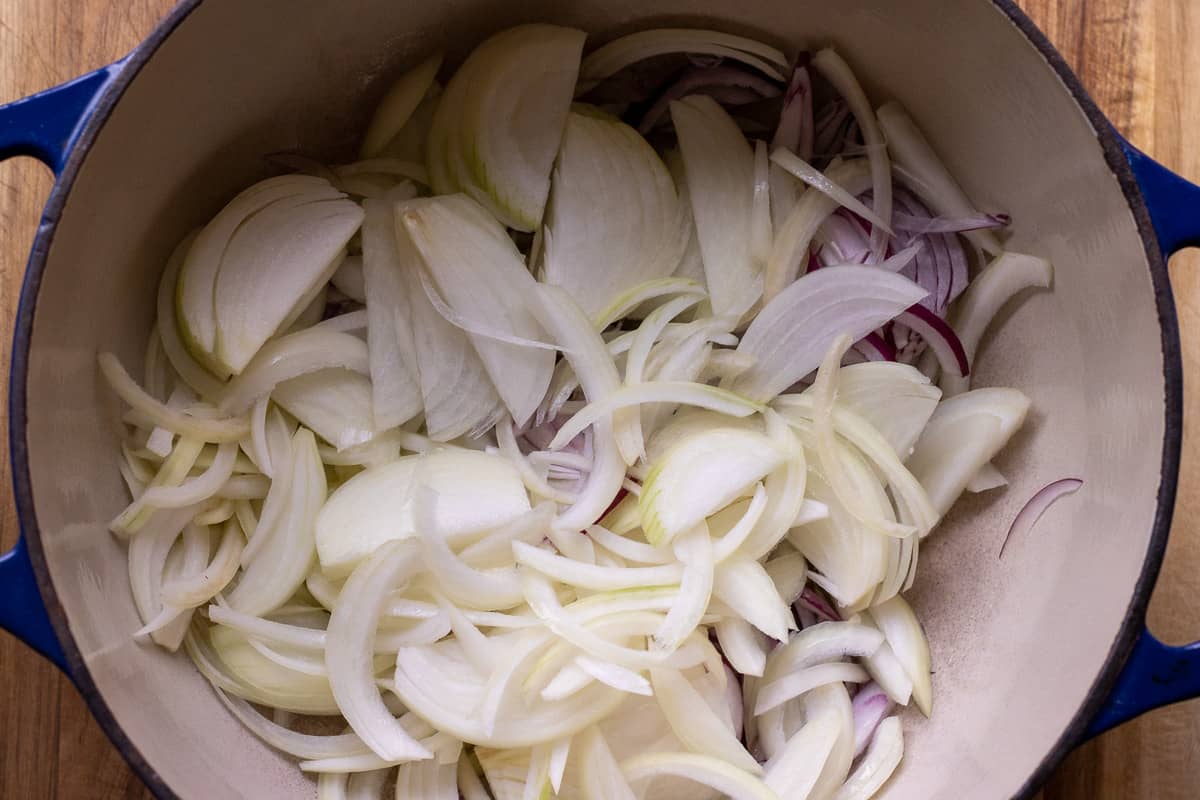 sliced onions are added to the pan
