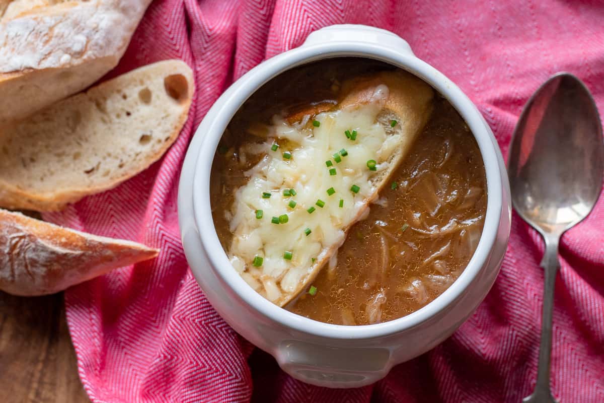 French onion soup served with sliced baguette