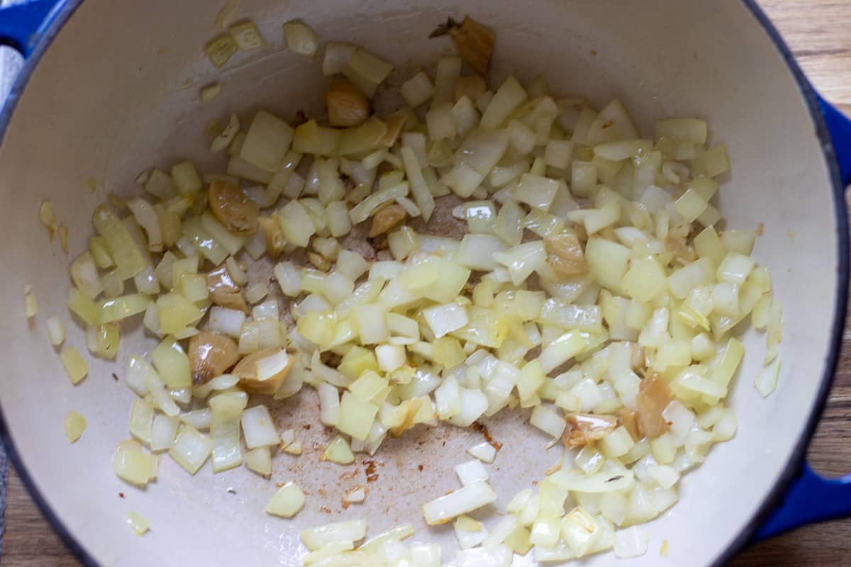 Sautéing the onions with olive oil in a Dutch oven 
