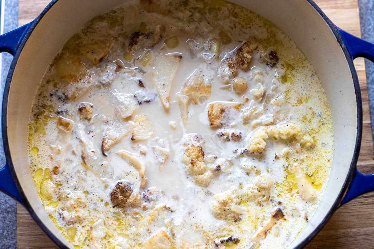 Cauliflower and celery root soup is cooked until tender