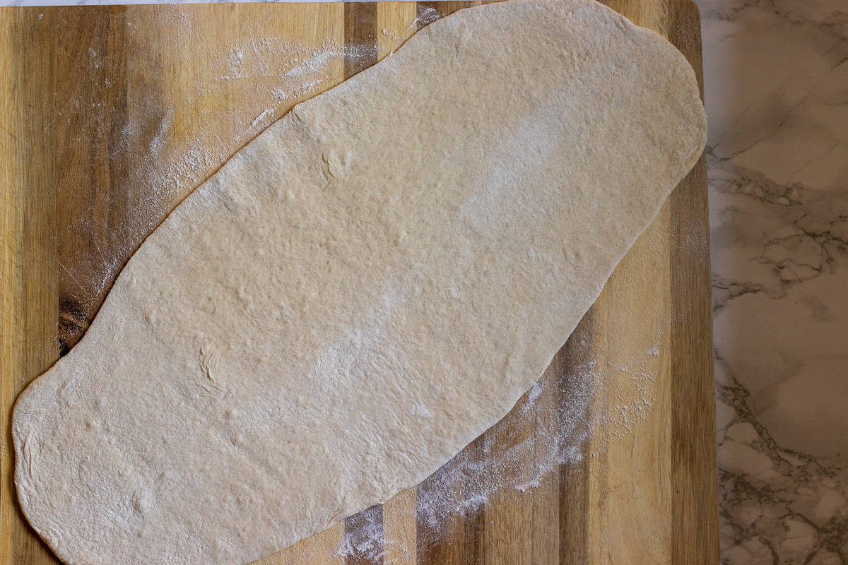 one the dough ball is rolled out in an oval shape