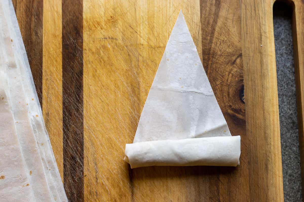 rolling the yufka triangle into a log shape