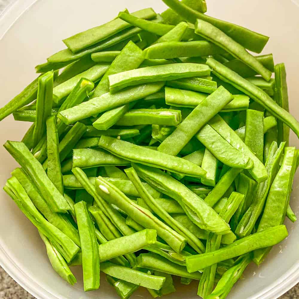 green beans are cut and trimmed for cooking