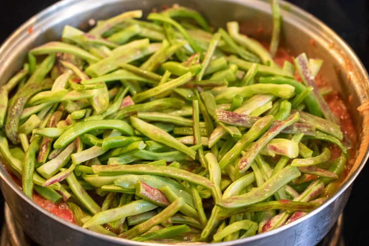 green beans are added to the pan