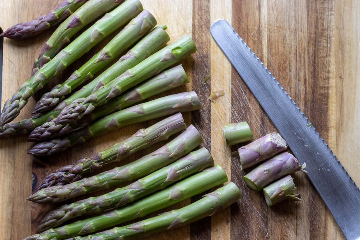 cutting the woody bits of asparagus before cooking them