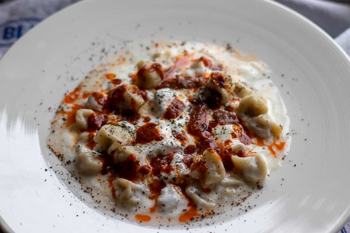manti is typically served with tomato butter sauce and garlicky yogurt 