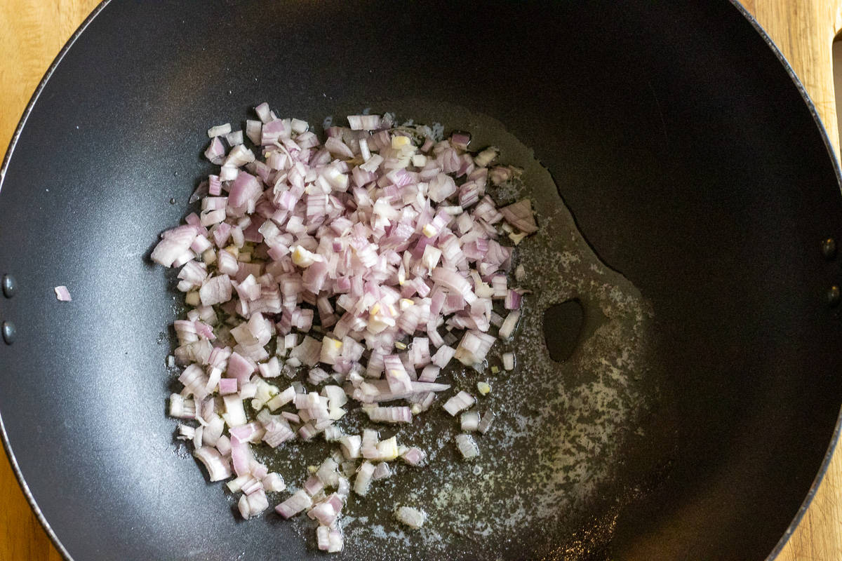 Sautéing the shallots with butter in a wok