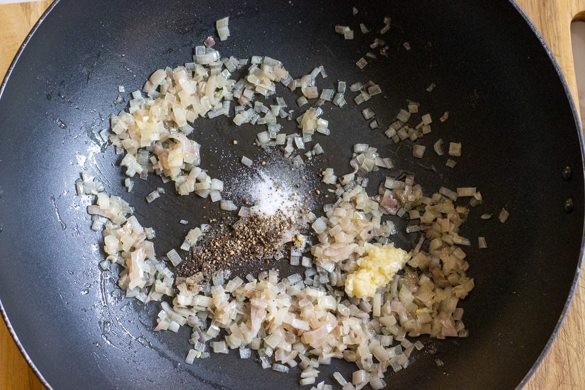 garlic, salt and pepper are added to the shallots