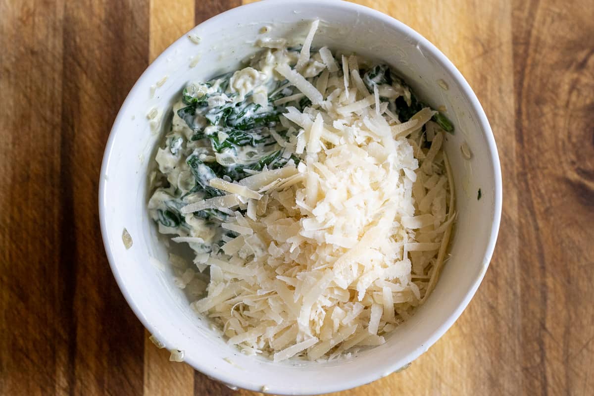 cream cheese and parmesan are added to the spinach