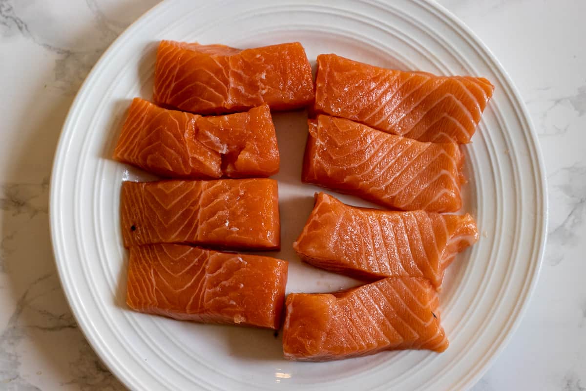 8 small salmon pieces on a plate