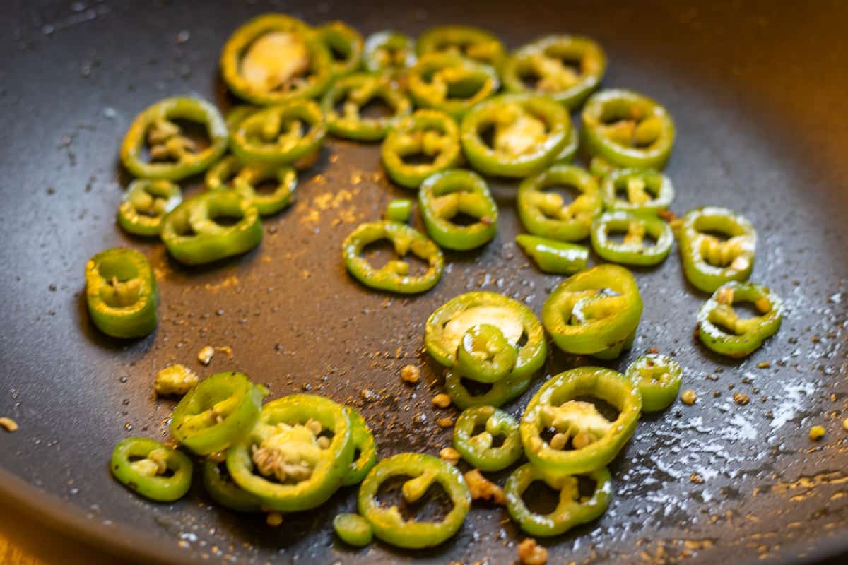 Sautéing the peppers with butter in a pan