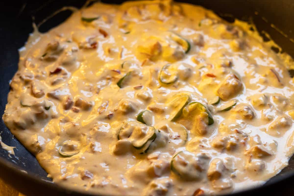 double cream added to the pan with peppers and tomatoes