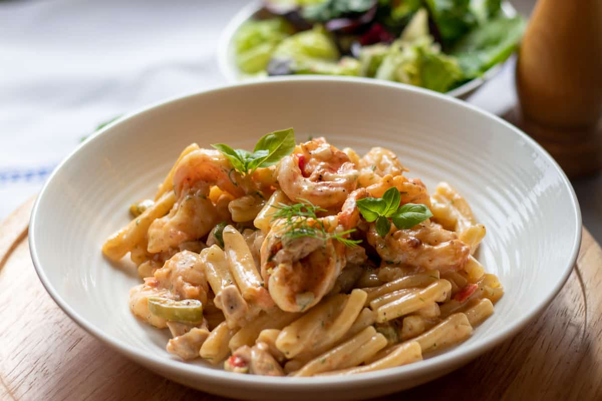 freshly cooked cajun chicken and prawn pasta served in a bowl