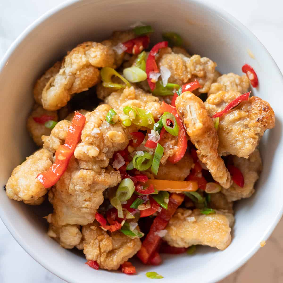 salt and pepper chicken served in a bowl
