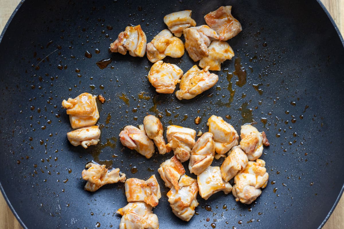 cooking the chicken pieces in the same wok
