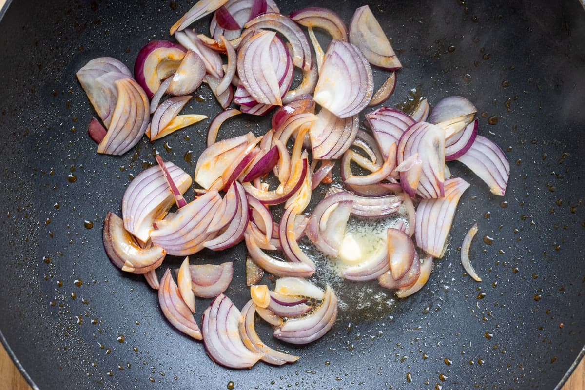 Sautéing the sliced onions with butter