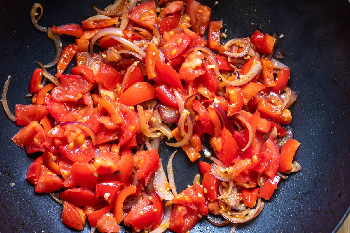 the tomatoes are added to the pan