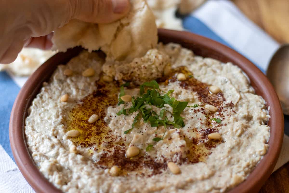 dipping in mutabal with pita bread