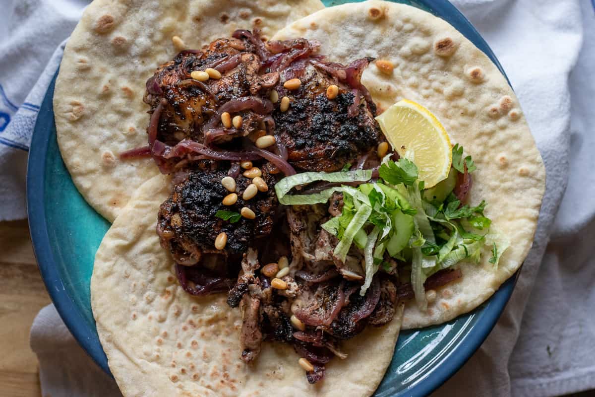 musakhan is served on a Flatbread with pine nuts and caramelised onions