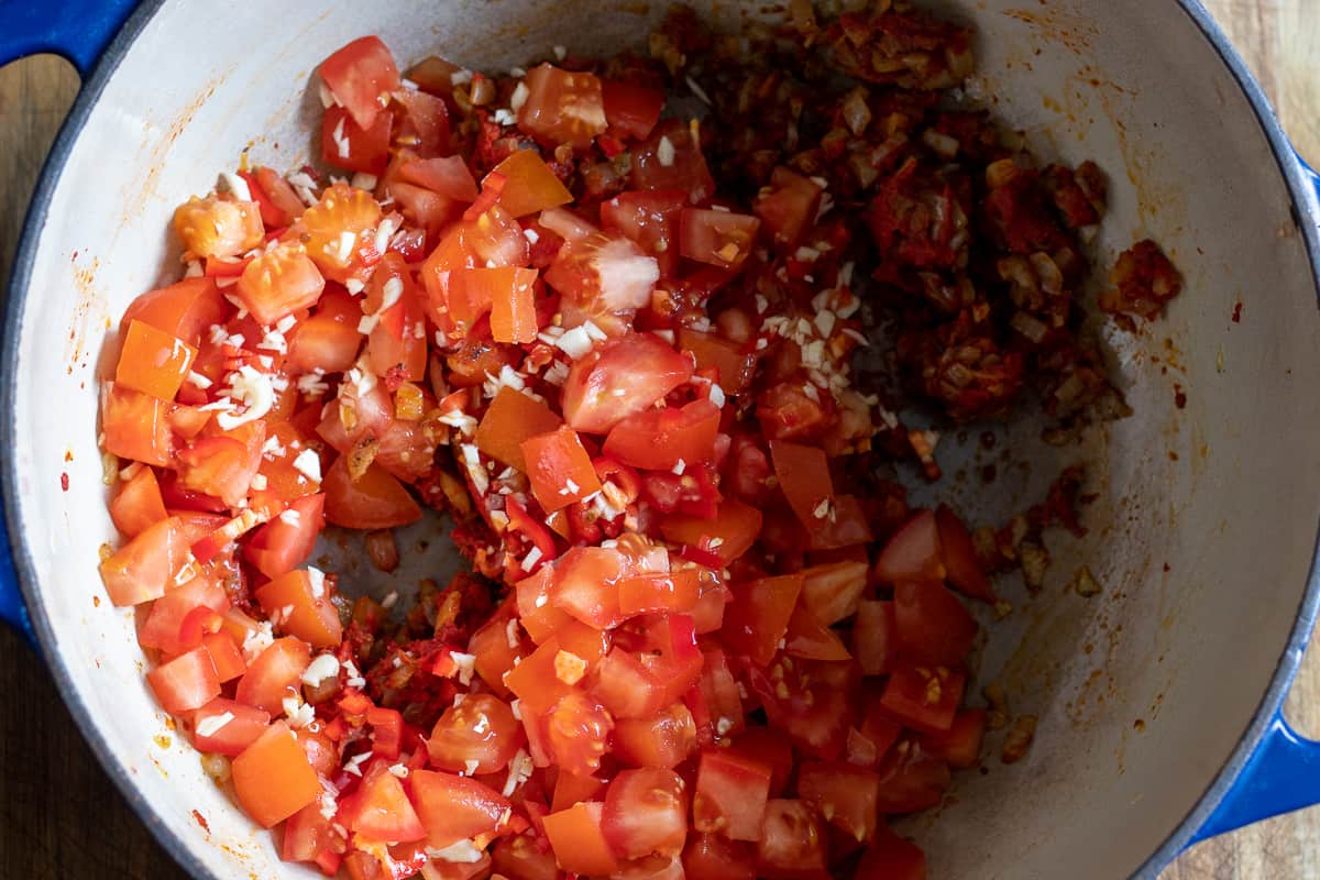 chopped tomatoes, garlic and chilli are added to the pan