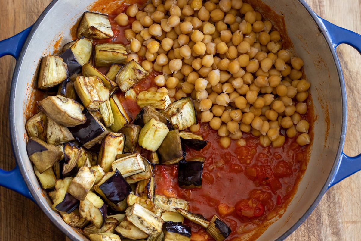 roasted eggplants and chickpeas are added to the pan