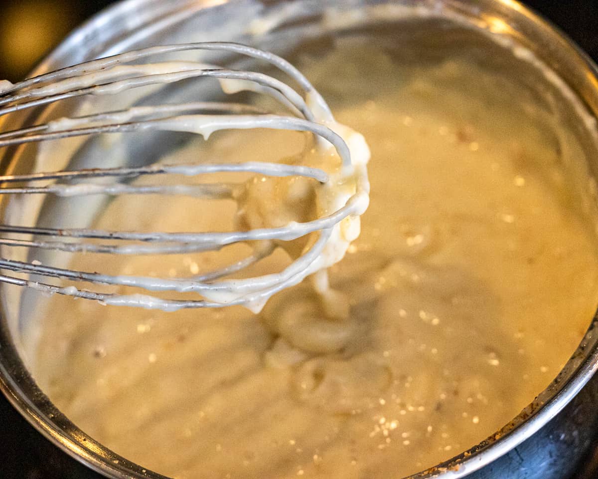 Add cheese to béchamel when thickened.