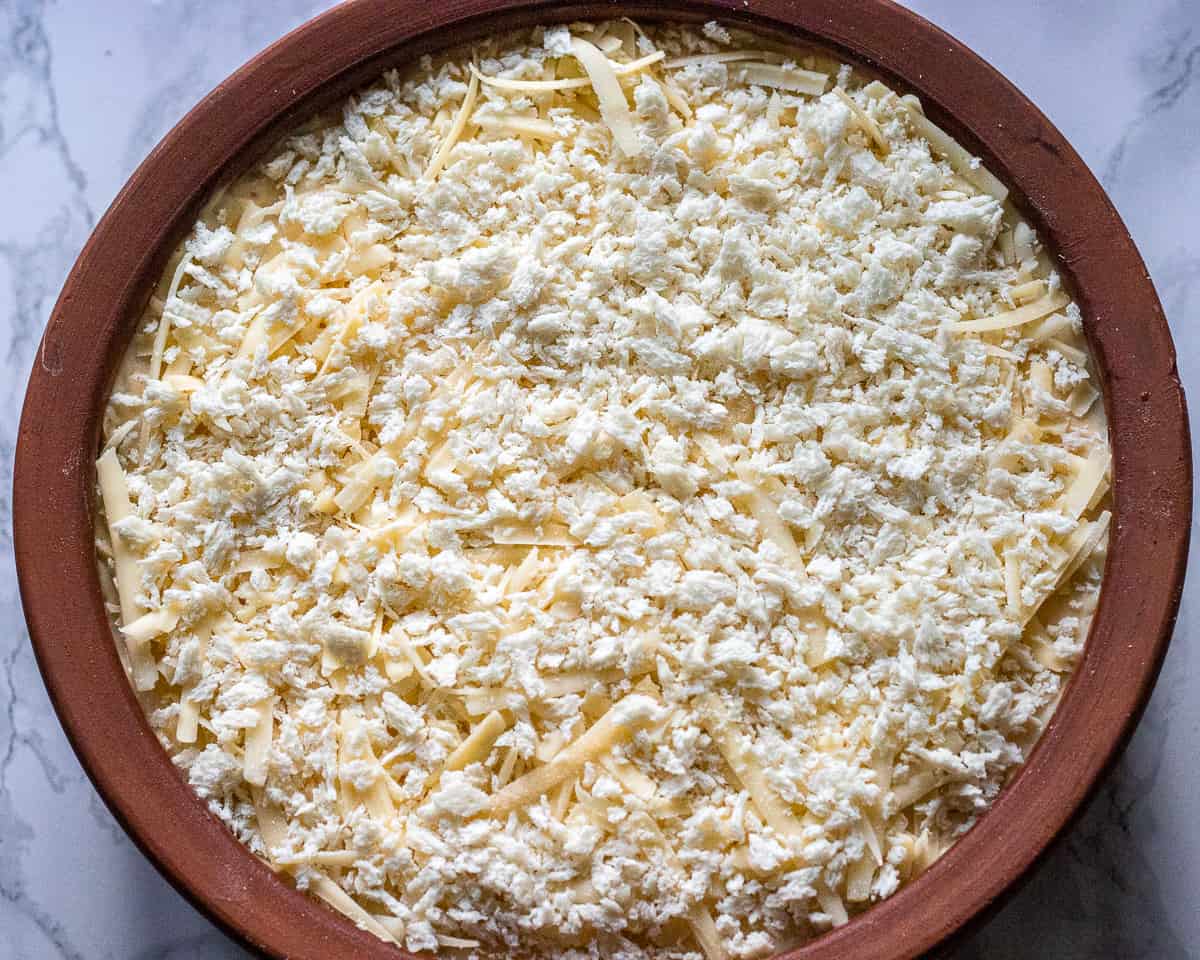 Grated cheese and breadcrumbs added to the top of the béchamel.