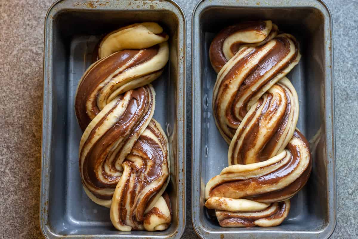 shaped babka are placed in two baking pan and let rise for 2 hours