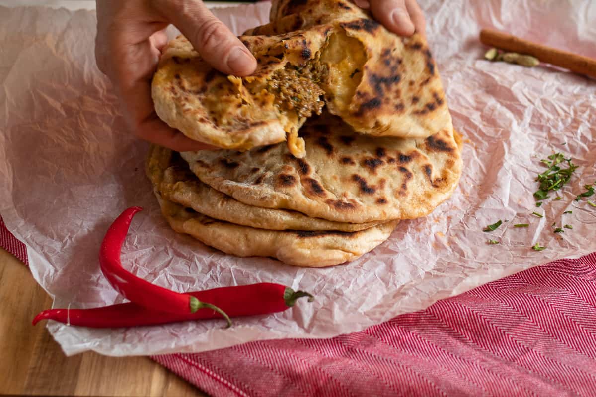 4 pieces of keema naan bread and 2 red chillies