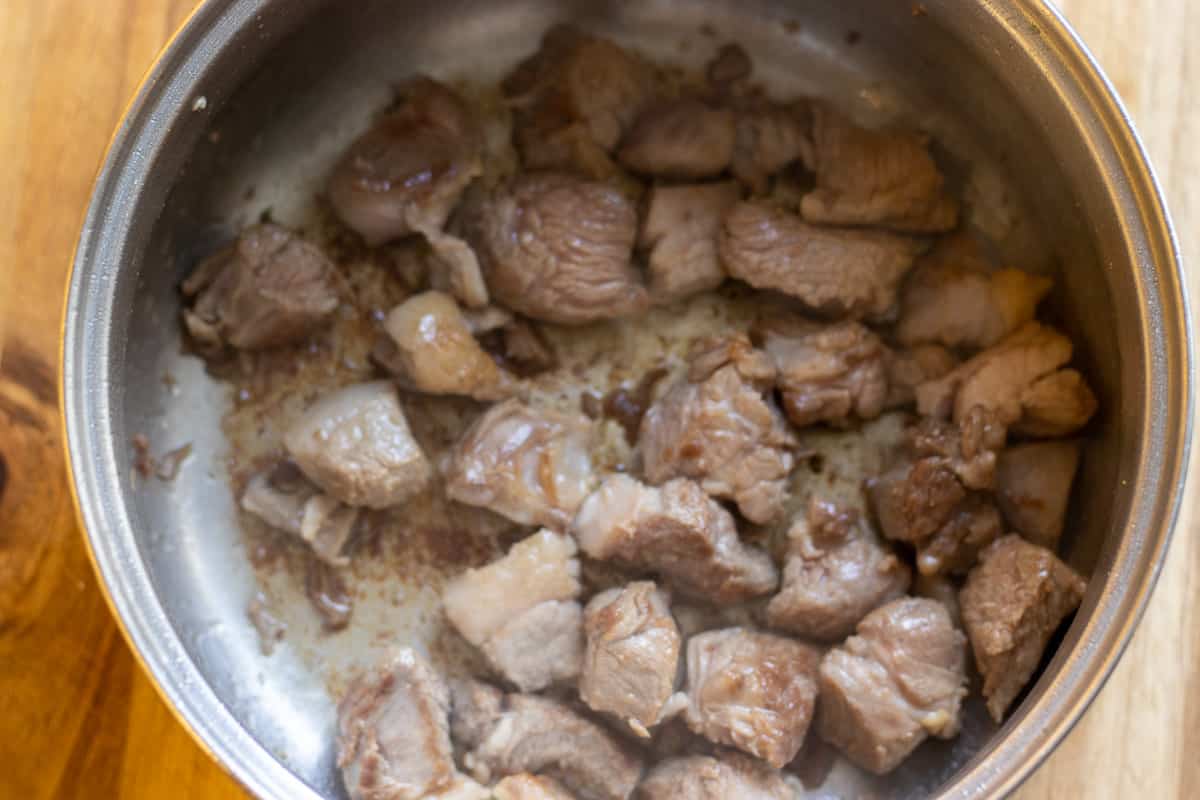 Browning the lamb in a pan with olive oil