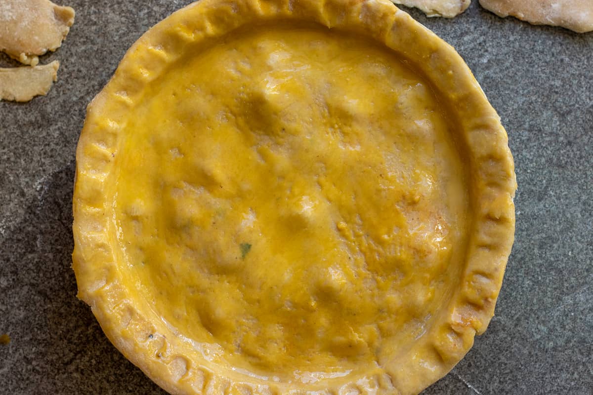 steak pie is covered with shortcrust pastry