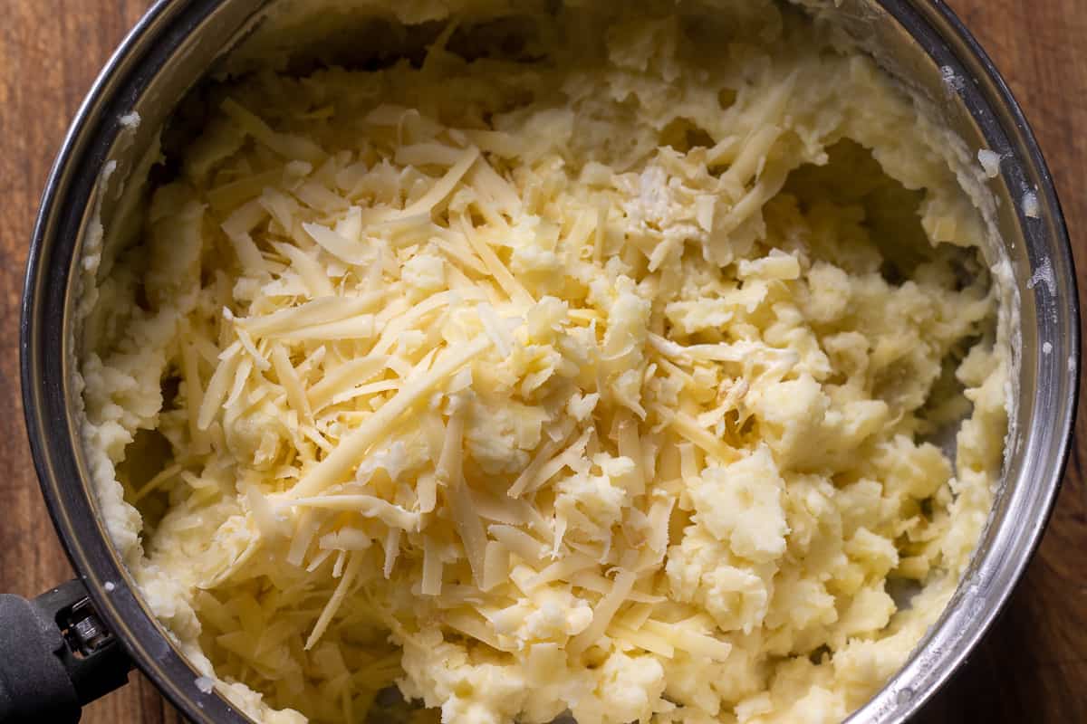 grated cheese is added to the mashed potatoes