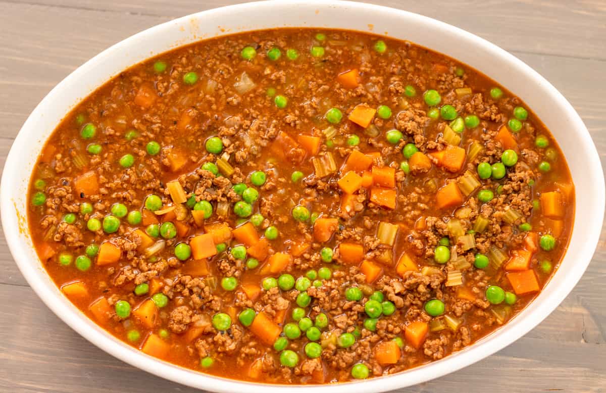 cottage pie filling is transferred into an oven dish