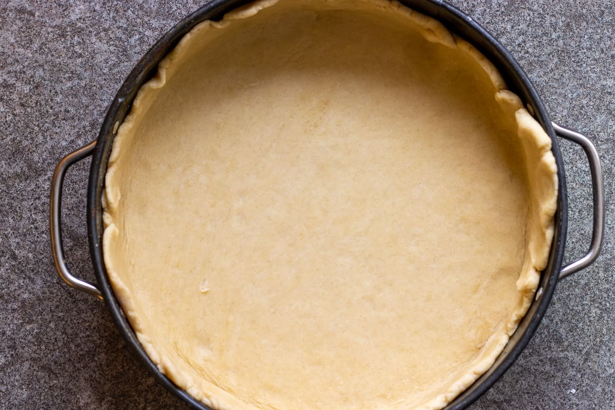 the pastry rolled out and lined the bottom of the cake tin