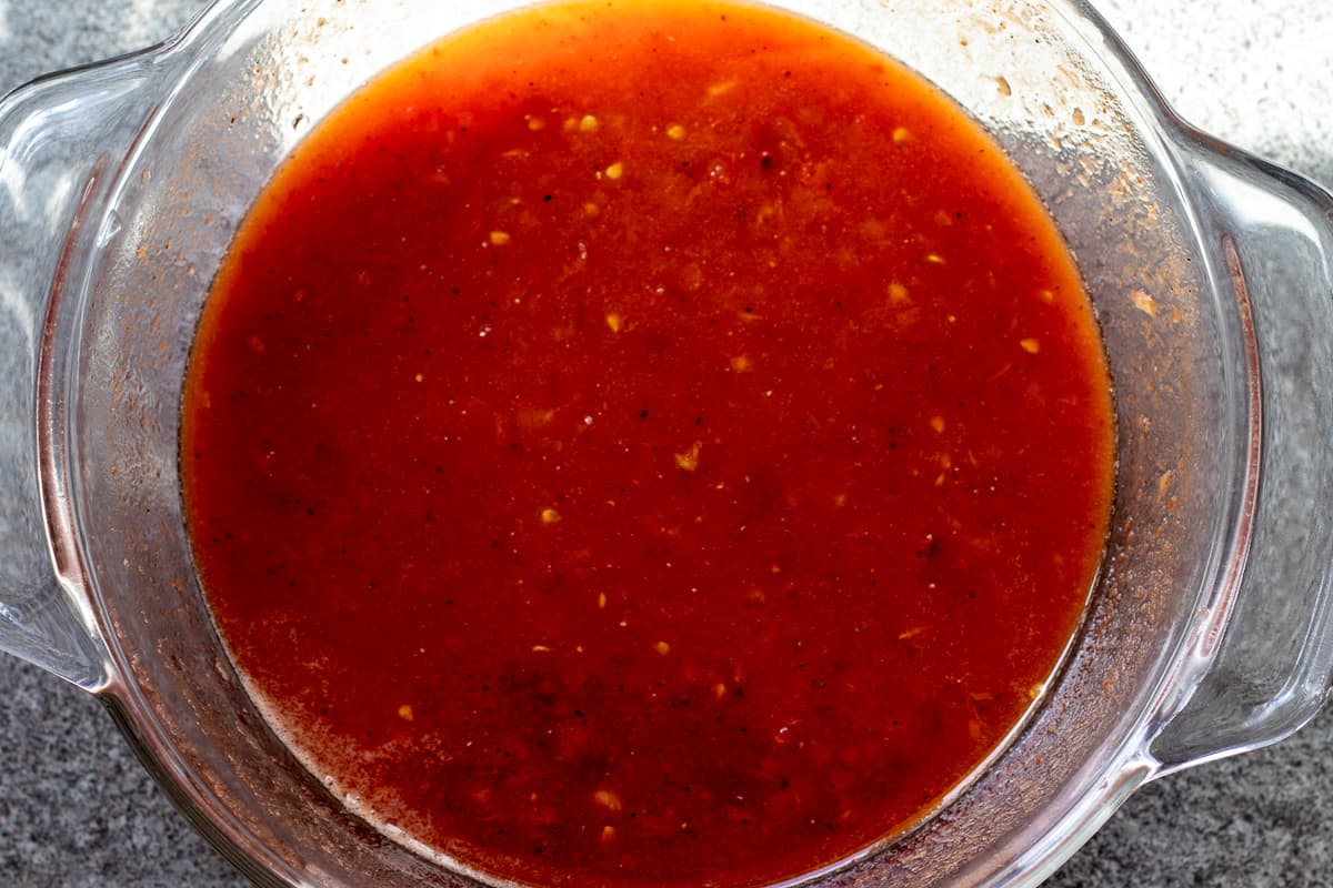 the water is added to tomatoes and tomato paste, and mixed to combine