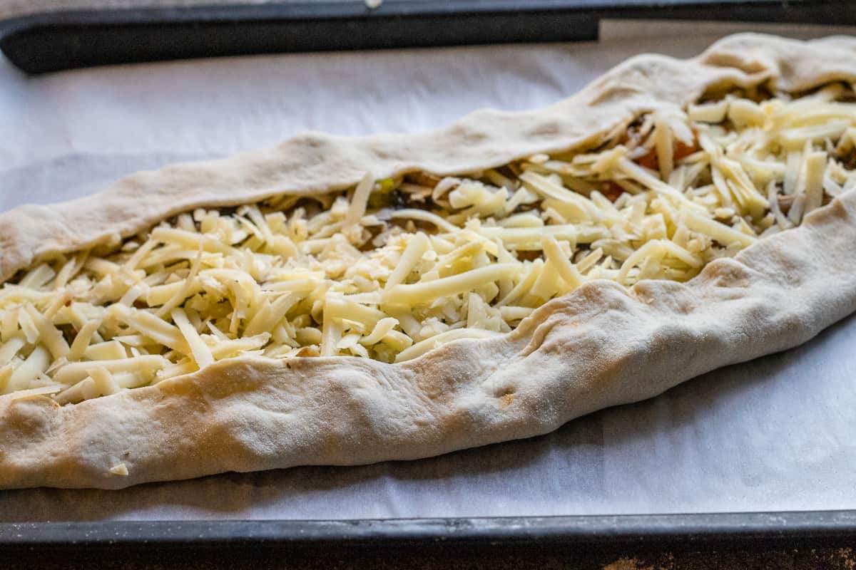 cheese and mushrooms are placed on top of the dough