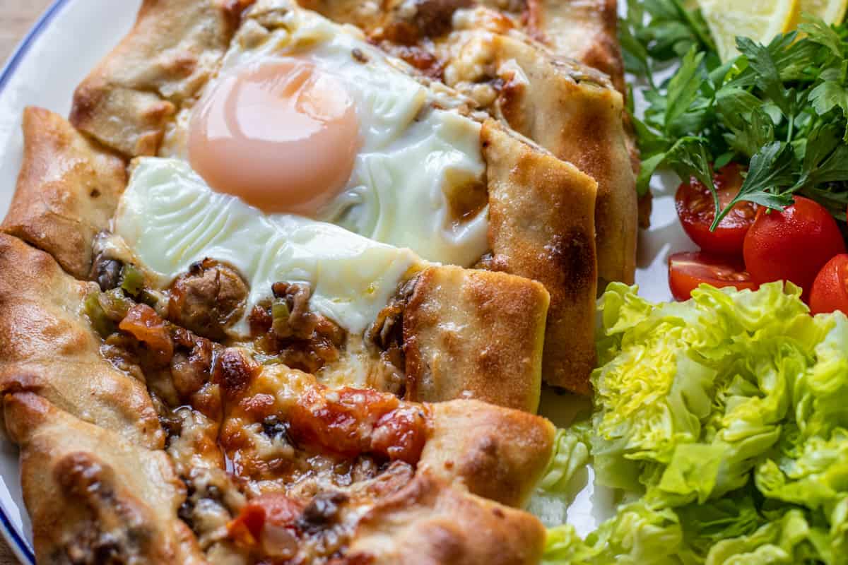 cheese and mushroom pide topped with an egg