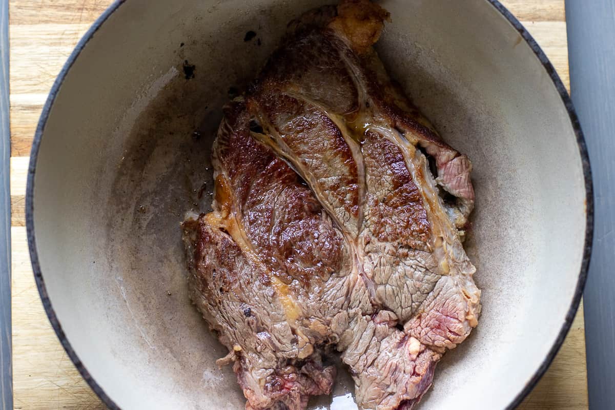searing the chuck roast in a dutch oven