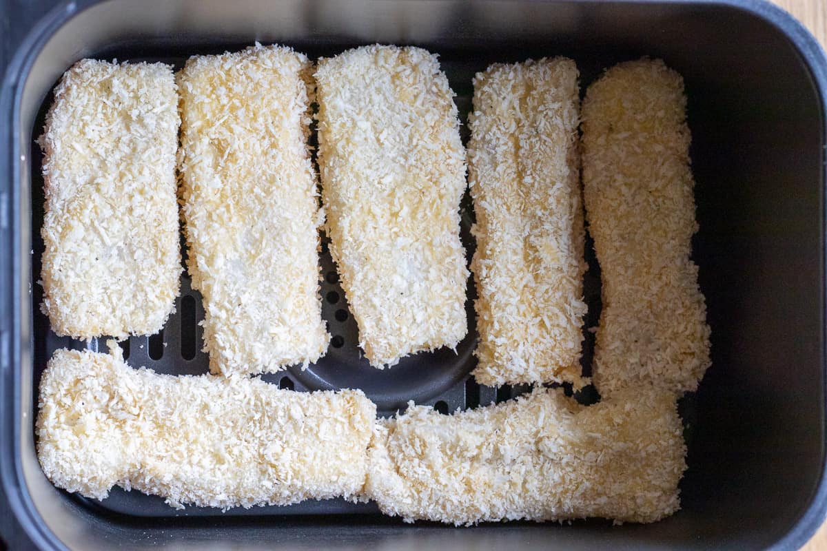 fish sticks are layered in air fryer basket