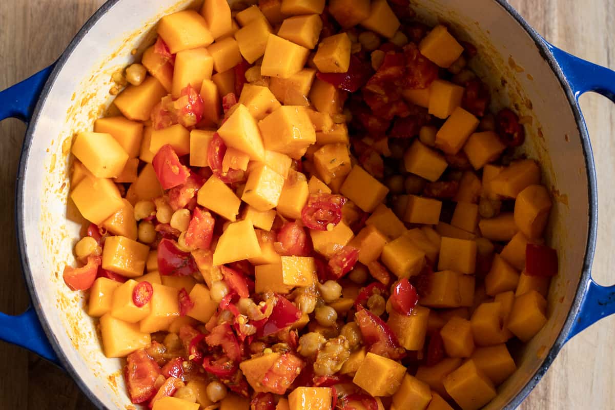 butternut squash and curry are added to the pan