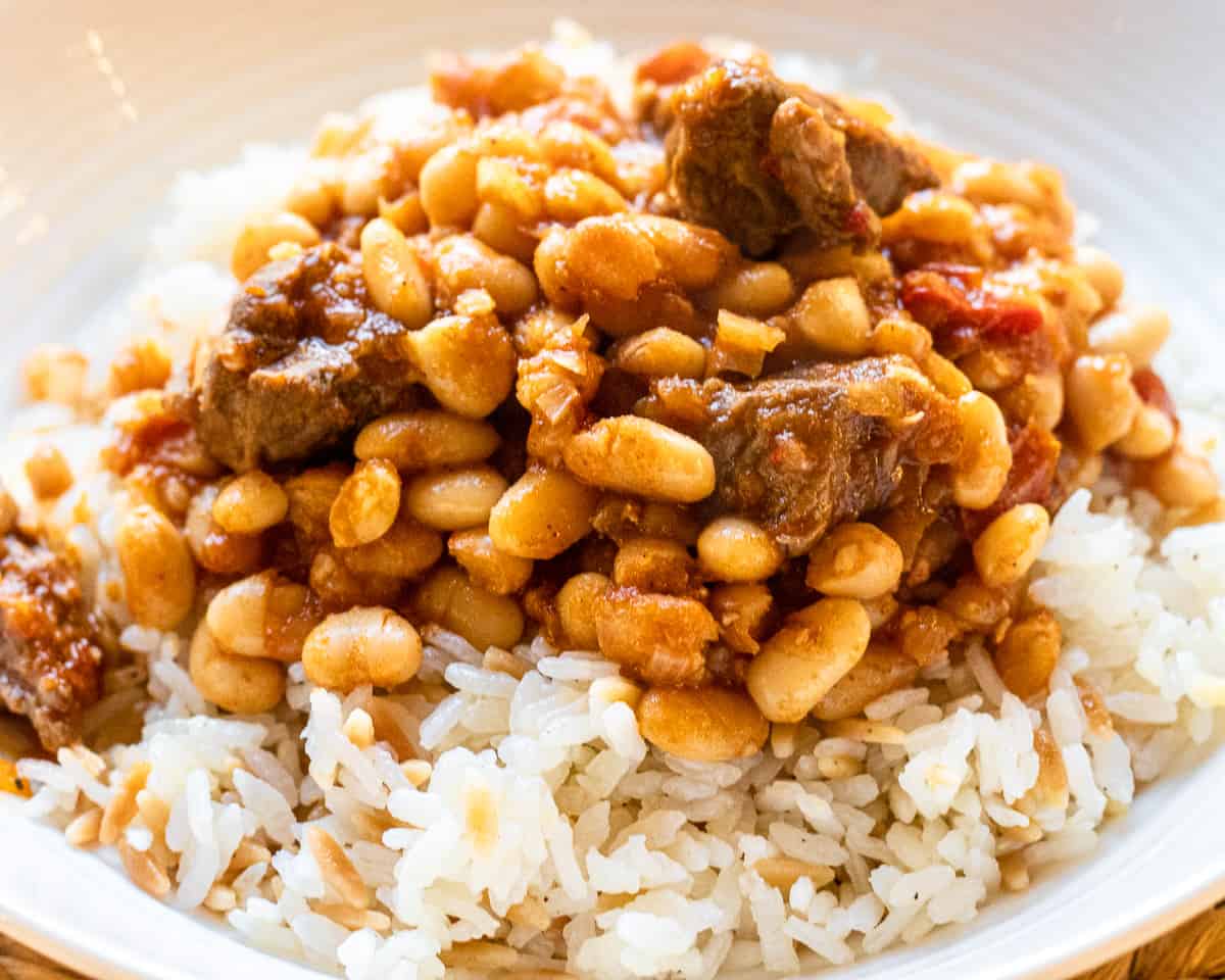 White bean stew with lamb served with Turkish rice pilaf.
