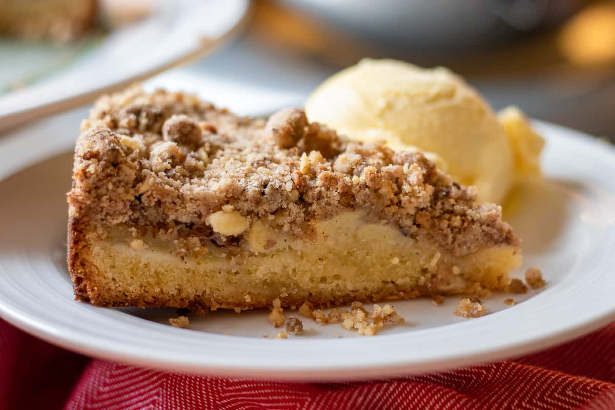 a slice of apple crumble cake served with ice cream