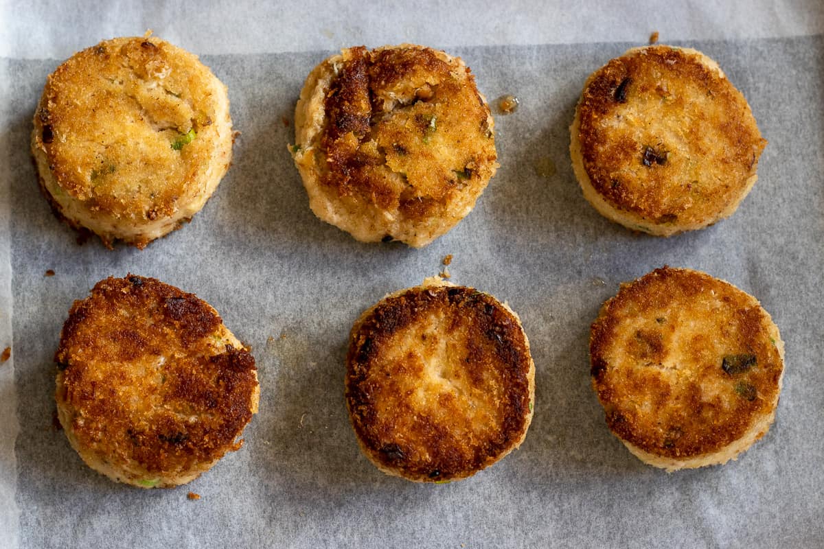 crab cakes are pan fried before air frying for a deeper golden colour