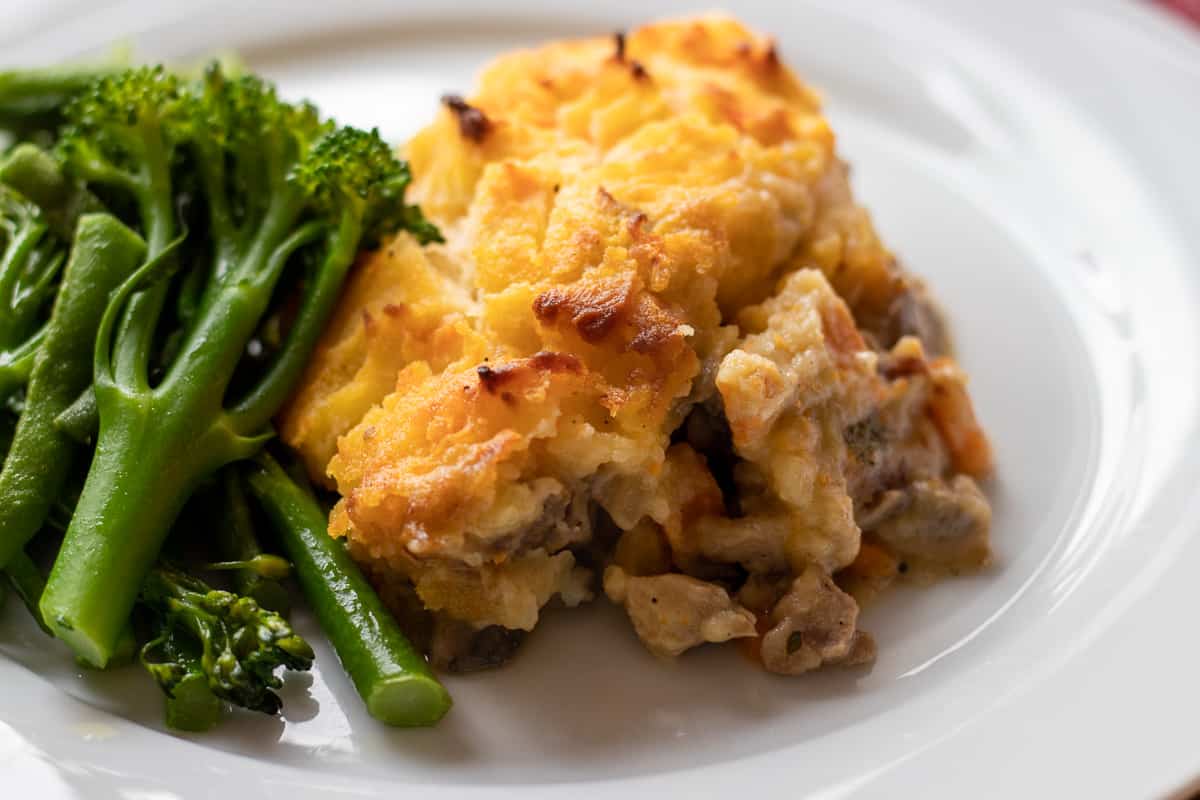 a portion of turkey shepherd pie served with steamed vegetables