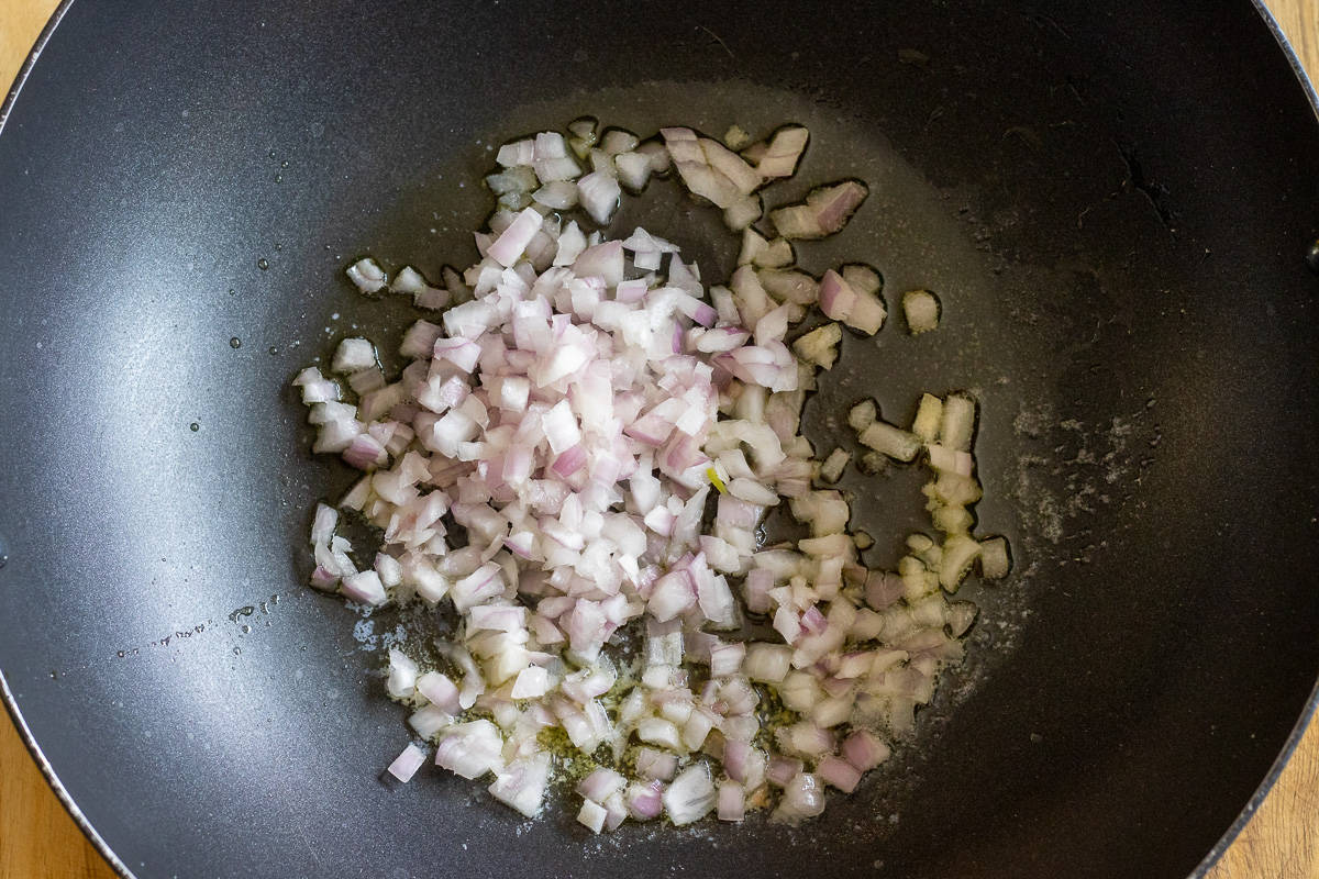 Sautéing the onions in a wok
