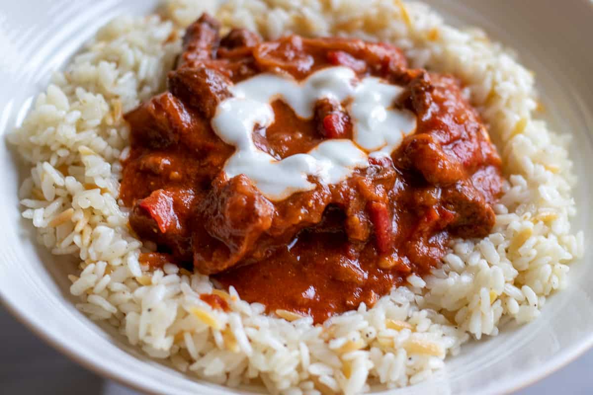 lamb goulash served on a bed of rice pilav